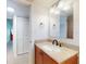 Bathroom vanity with a granite countertop, undermount sink, dark faucet, and mirrored medicine cabinet at 315 N Causeway # 405, New Smyrna Beach, FL 32169