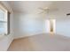 Spacious bedroom with neutral carpet, ceiling fan, and a sunny window at 315 N Causeway # 405, New Smyrna Beach, FL 32169