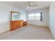 Bedroom featuring a large window, ceiling fan, and dresser with mirror at 315 N Causeway # 405, New Smyrna Beach, FL 32169