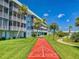 Community shuffleboard court with vibrant colors, set amidst a beautifully landscaped lawn at 315 N Causeway # 405, New Smyrna Beach, FL 32169