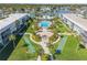 Aerial view of a condo community with large pool and shuffleboard courts at 325 N Causeway # B101, New Smyrna Beach, FL 32169