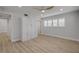 Bedroom featuring wood-look flooring, a ceiling fan, window shutters, and custom storage at 325 N Causeway # B101, New Smyrna Beach, FL 32169