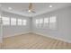 Bedroom featuring wood-look flooring, a ceiling fan, and window shutters at 325 N Causeway # B101, New Smyrna Beach, FL 32169