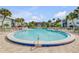 Well-maintained condo community pool surrounded by lounge chairs and lush tropical landscaping at 325 N Causeway # B101, New Smyrna Beach, FL 32169