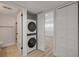 Efficient laundry closet with stacked washer and dryer, situated near the bathroom and bedroom at 325 N Causeway # B101, New Smyrna Beach, FL 32169