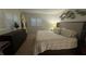 Comfortable bedroom with plantation shutters, surfboard decor, and natural light at 325 N Causeway # B101, New Smyrna Beach, FL 32169