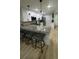 Modern kitchen featuring white cabinets, granite countertops, stainless steel appliances, and bar stool seating at 325 N Causeway # B101, New Smyrna Beach, FL 32169