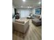 Bright living room with a large sectional sofa, modern furnishings, and wood-look floors at 325 N Causeway # B101, New Smyrna Beach, FL 32169