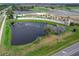 Aerial of the community entrance with pond, fountains, and landscaping at 3368 Tuscano Ne Ave, New Smyrna Beach, FL 32168