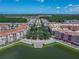 A beautiful aerial showcases lakefront apartments with lush landscaping and a serene waterfront promenade at 3368 Tuscano Ne Ave, New Smyrna Beach, FL 32168