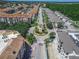 High angle view of condos, community clock tower, and tree lined streets in development at 3368 Tuscano Ne Ave, New Smyrna Beach, FL 32168