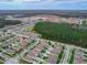 Aerial view of a home in a residential area with green landscaping and nearby community amenities at 3368 Tuscano Ne Ave, New Smyrna Beach, FL 32168