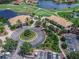 Aerial view of the clubhouse, golf course, and lake in luxurious planned community at 3368 Tuscano Ne Ave, New Smyrna Beach, FL 32168