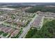 An aerial view shows a well-planned community with tree-lined streets, sidewalks, and a mix of single-Gathering homes at 3368 Tuscano Ne Ave, New Smyrna Beach, FL 32168