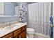 Bright bathroom featuring a vanity with marble countertop and a shower with patterned curtains at 3368 Tuscano Ne Ave, New Smyrna Beach, FL 32168