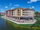 Charming waterfront condominium complex with balconies and outdoor dining area overlooking the canal at 3368 Tuscano Ne Ave, New Smyrna Beach, FL 32168