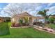 Charming single-story home featuring lush landscaping, a well-manicured lawn, and a welcoming front entrance at 3368 Tuscano Ne Ave, New Smyrna Beach, FL 32168