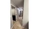 View of hallway showcasing tile flooring, a closet, and a black framed mirror at 3368 Tuscano Ne Ave, New Smyrna Beach, FL 32168