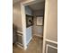 Hallway with light gray walls, white trim, two framed prints, and tan tile floor at 3368 Tuscano Ne Ave, New Smyrna Beach, FL 32168