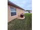 Neat side yard view showing the home's exterior and minimal landscaping at 3368 Tuscano Ne Ave, New Smyrna Beach, FL 32168