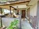 A home's charming front entrance with covered porch, stone pillar and secure, gated walkway at 3656 Jackson St # A-2, Port Orange, FL 32129