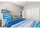 The bedroom features a blue bedspread, a ceiling fan, and a painted dresser at 3783 Sweet Grove Ct, Port Orange, FL 32129