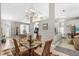 Elegant dining room with glass table, chandelier, and seamless flow into the kitchen at 3783 Sweet Grove Ct, Port Orange, FL 32129