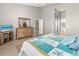 This main bedroom features a coastal motif with a starfish quilt and wood-look floors at 3783 Sweet Grove Ct, Port Orange, FL 32129