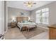 The spacious primary bedroom features light gray walls, wood look floors, a ceiling fan, and a large window at 3783 Sweet Grove Ct, Port Orange, FL 32129