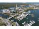 Picturesque aerial view featuring a marina filled with boats, buildings, and a bridge over the water at 43 Jacaranda Cay Ct # 430, New Smyrna Beach, FL 32169