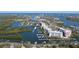 An aerial view highlights the property's dock and proximity to the water at 43 Jacaranda Cay Ct # 430, New Smyrna Beach, FL 32169