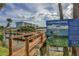 Picturesque view of dock with waterfront condos and boating safety information for a vibrant coastal lifestyle at 43 Jacaranda Cay Ct # 430, New Smyrna Beach, FL 32169