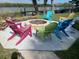 A cozy fire pit area with colorful Adirondack chairs is perfect for outdoor gatherings at 43 Jacaranda Cay Ct # 430, New Smyrna Beach, FL 32169