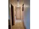 Hallway with tile flooring, neutral paint, and access to various rooms at 434 Palmetto St, Edgewater, FL 32132