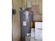 Image shows a Rheem water heater with energy guide sticker and connection to nearby washing machine at 434 Palmetto St, Edgewater, FL 32132