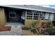 The back patio features lush landscaping, a brick paver patio, and access to the home's screened-in porch at 45 Sandra Cir, New Smyrna Beach, FL 32168