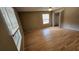 An empty bedroom features hardwood floors, a ceiling fan, and multiple windows at 45 Sandra Cir, New Smyrna Beach, FL 32168