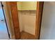 An empty bedroom closet with bifold wood doors and one shelf above the hanging bar at 45 Sandra Cir, New Smyrna Beach, FL 32168