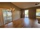 Bright dining area with chandelier, wood floors, sliding doors to patio, and neutral wall color at 45 Sandra Cir, New Smyrna Beach, FL 32168