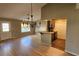 Open-concept dining area with hardwood floors, a modern chandelier, and an eat-in kitchen bar at 45 Sandra Cir, New Smyrna Beach, FL 32168