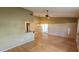 Open-concept living room featuring hardwood floors and lots of natural light at 45 Sandra Cir, New Smyrna Beach, FL 32168