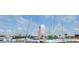 Boats docked at a marina with a lighthouse in the distance on a clear, sunny day at 45 Sandra Cir, New Smyrna Beach, FL 32168