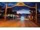 Night view of Flagler Avenue with its decorative arch and lights, showcasing the vibrant street scene at 45 Sandra Cir, New Smyrna Beach, FL 32168