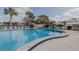 Large, curved community pool with blue tile, lounge chairs, palm trees, and a lifeguard station at 456 Shorewood Ln, New Smyrna Beach, FL 32168