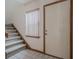 Bright foyer with a staircase, tiled floor, and a white front door at 456 Shorewood Ln, New Smyrna Beach, FL 32168