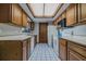 Functional kitchen with wooden cabinets, white appliances, and a bright overhead light at 456 Shorewood Ln, New Smyrna Beach, FL 32168