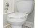 A white toilet with a matching white tank and seat, set against a black and white tile floor at 47 Jacaranda Cay Ct # 470, New Smyrna Beach, FL 32169