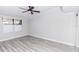 Clean bedroom with neutral walls, window and light gray wood-look flooring at 47 Jacaranda Cay Ct # 470, New Smyrna Beach, FL 32169