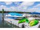 View of a covered boat and kayaks docked by the waterfront at 47 Jacaranda Cay Ct # 470, New Smyrna Beach, FL 32169