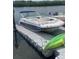 A well-maintained boat rests on a floating dock, ready for aquatic adventures at 47 Jacaranda Cay Ct # 470, New Smyrna Beach, FL 32169